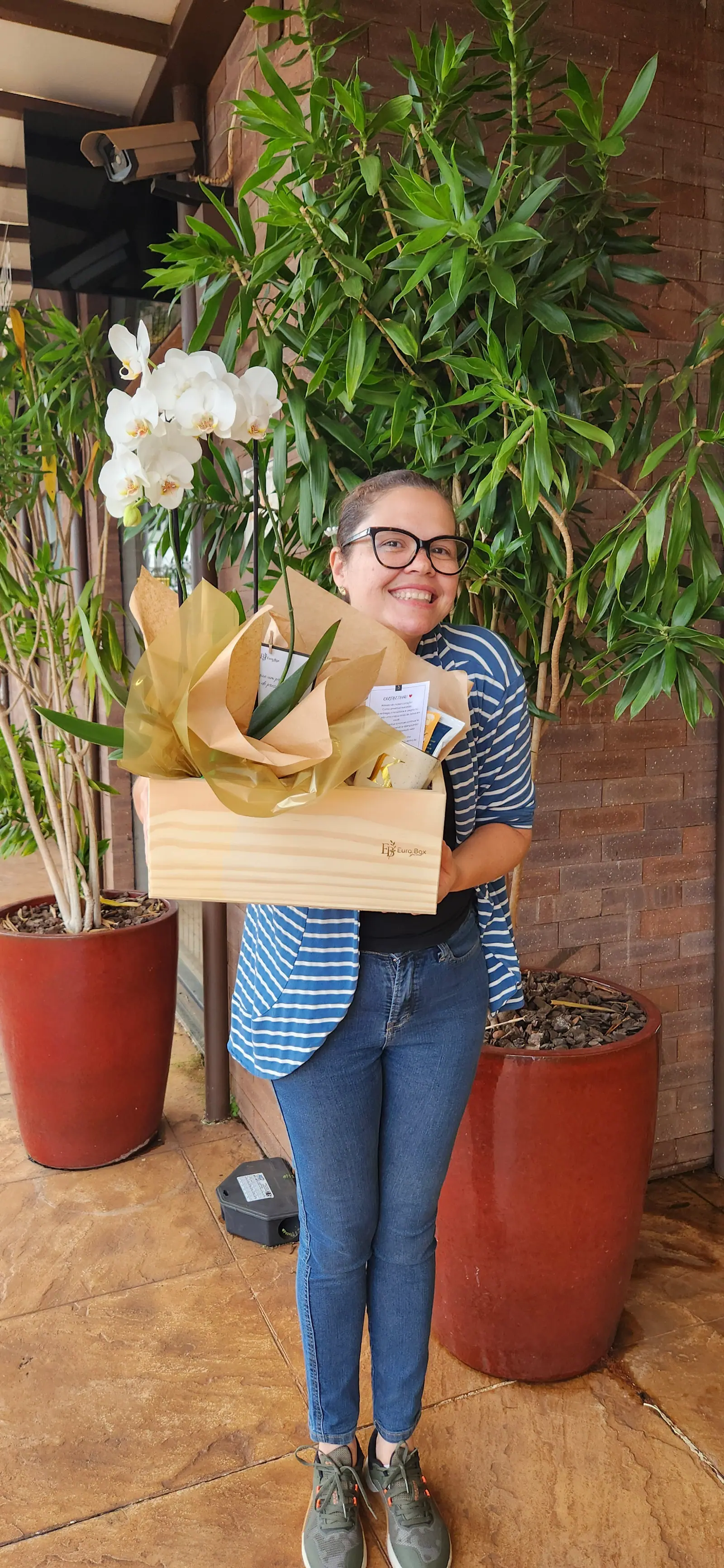Foto da cliente Karen segurando a cesta gourmet personalizada da EuroBox